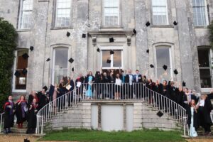 Coastland College graduates celebrate outside Kingston Maurward House